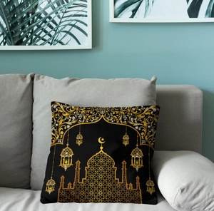 Detail of black pillow cover with gold moon and mosque print on modern sofa