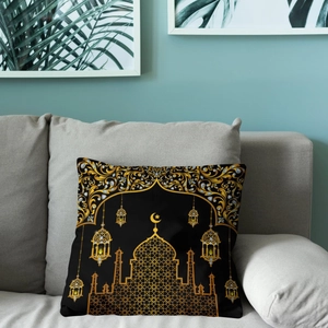 Linen pillowcase with golden moon, stars, and mosque print on a gray sofa