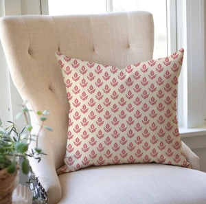 Floral print throw pillow with red leaf patterns on a cream cushion cover for sofa decor