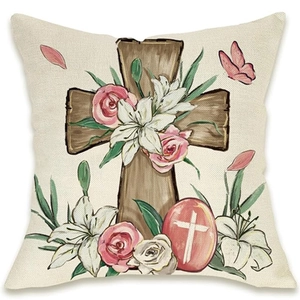 Detail of linen Easter pillow cover featuring a wooden cross with pink roses and lilies