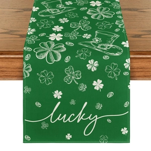 Detail of St. Patrick's Day table runner with lucky clover and hat on green fabric