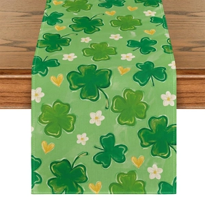 Detail of green St. Patrick's clover table runner on a dark wood table surface