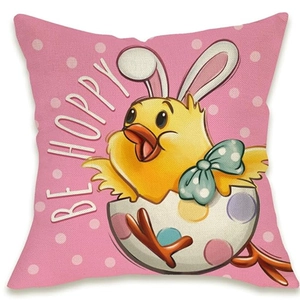 Detail of linen texture pillowcase featuring cartoon chicken in easter egg with BE HOPPY text