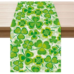 St. Patrick's Day table runner with green clover patterns on white rustic wood surface