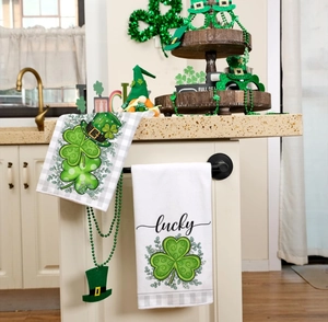 Detail of St. Patrick's Day kitchen towels with shamrock and lucky text in a home setting