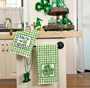 Detail of St. Patrick's Day kitchen towels with lucky shamrocks and green plaid patterns