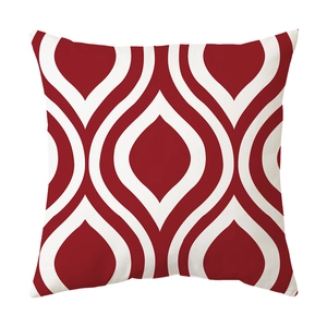 Close-up of square cushion cover with red and white geometric wave patterns on canvas fabric