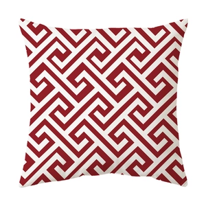 Detail view of red and white Greek Key geometric pattern on square cushion cover fabric