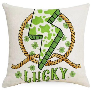 Close-up of linen cushion cover with green clover and lucky lightning bolt print