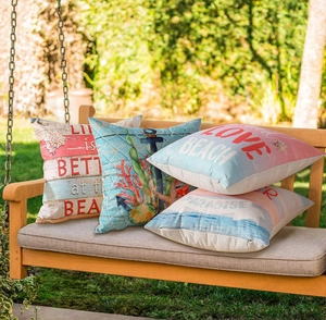 Set of 4 waterproof outdoor pillows featuring starfish and anchors on a garden swing