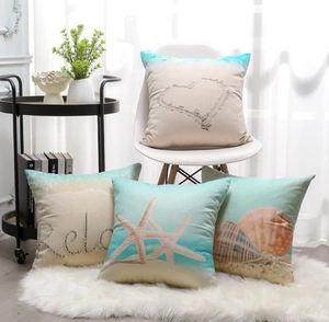 Detail of four linen waterproof outdoor pillow covers with starfish and seashell beach motifs