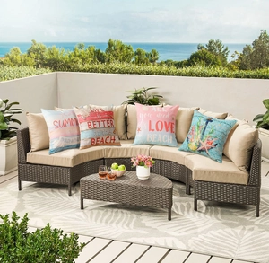 Detailed outdoor view of four waterproof linen beach pillows with starfish and anchor motifs