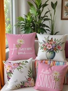 Detailed view of floral linen pillow covers with sweet home text on a white sofa
