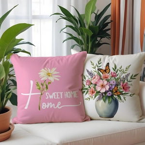 Detail of floral linen cushion covers with Home Sweet Home text and butterfly patterns