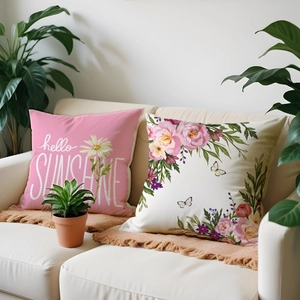 Detailed view of floral cushion set on sofa with hello SUNSHINE text and butterfly prints