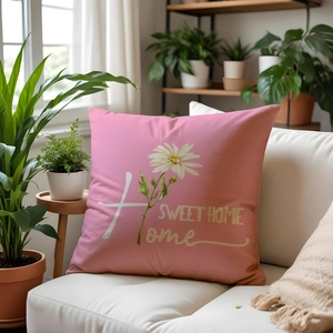 Close-up of a floral sofa cushion with daisy print and Sweet Home text in a cozy living room