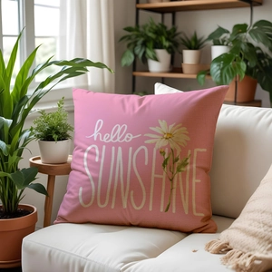 Detailed close-up of linen pillow texture with hello SUNSHINE print and daisy pattern