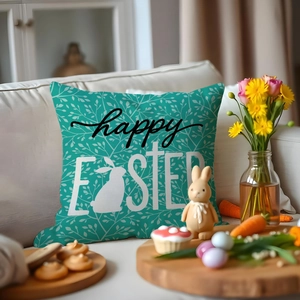 Easter throw pillow with white rabbit and Happy Easter text on teal couch setting
