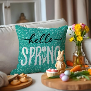 Close-up of mint green Easter pillow case with hello SPRING text and floral patterns