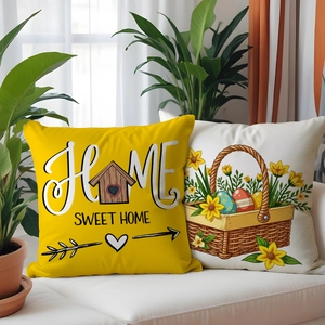 Close-up of linen pillow covers with Home Sweet Home text and Easter floral basket patterns
