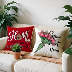 Detail of floral and letter print throw pillows featuring tulip and birdhouse designs
