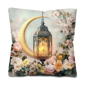 Detail view of Ramadan cushion cover with moon, lantern and floral pattern on white fabric