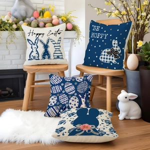 Close-up of four linen Easter pillow covers with navy blue rabbit and egg prints