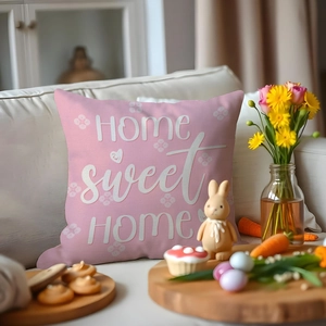 Pink Easter cushion cover with Home Sweet Home print on a white sofa setting