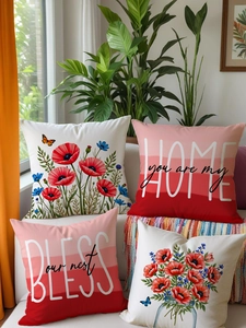 Detail of four Nordic style linen cushion covers with red poppy prints and home slogans