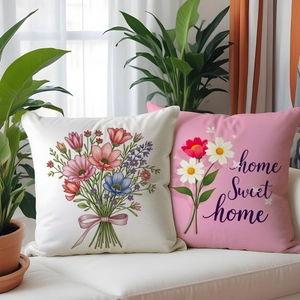 Floral and 'Home Sweet Home' decorative pillow set displayed on a white sofa