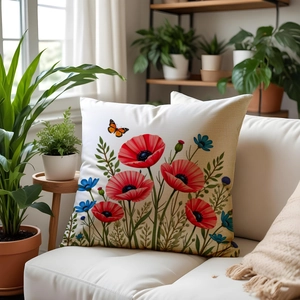 Detailed close-up of a floral sofa pillow cover with poppy and butterfly on a white sofa
