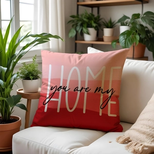 Detail of modern HOME decorative pillow case with red gradient and floral backdrop