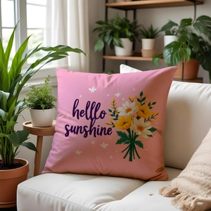 Detailed texture of pink floral linen pillow cover with hello sunshine print on sofa