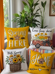 Set of 4 sunflower pillow covers with rustic spring prints on a cozy white sofa