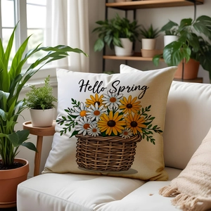 Detailed close-up of a floral Hello Spring throw pillow on a modern sofa with green plants