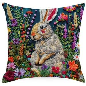 Macro view of floral rabbit embroidery texture on deep blue linen decorative pillow cover
