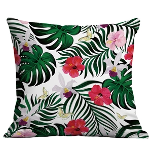 Detailed view of tropical cushion cover with hibiscus flowers and palm leaves print