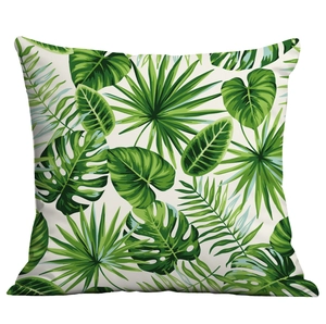 Close-up of tropical palm leaf pattern and fabric texture on square throw pillow cover