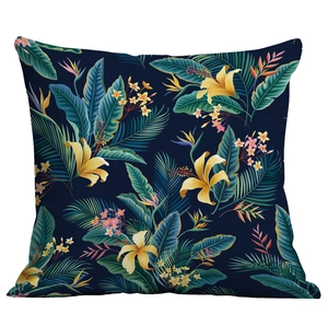 Navy blue throw pillow with vibrant tropical floral and palm leaf print for sofa