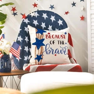 Close-up of patriotic linen pillowcase with because of the brave text and blue stars