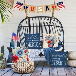 Outdoor patio set of 4 patriotic Independence Day pillow covers on a black rattan swing