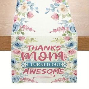 Linen Mother's Day table runner with pink floral patterns and thankful text on wood desk
