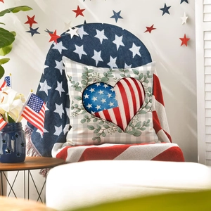 Patriotic heart American flag pillow on armchair with rustic Independence Day decor