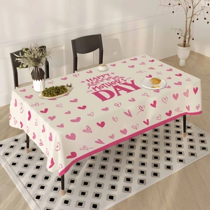 Detailed close-up of Mother's Day tablecloth with pink hearts and red holiday text