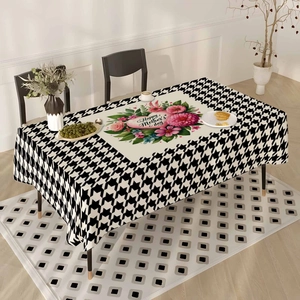 Detail of Happy Mother's Day tablecloth with floral wreath and houndstooth pattern