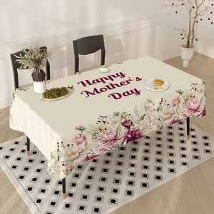 Detail of Happy Mother's Day tablecloth with elegant floral patterns on beige fabric