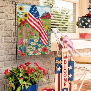 Detail of garden flag with American flag and sunflowers on a black metal hanger