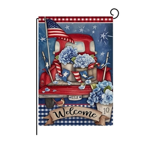Close-up of USA Independence Day garden flag with red truck and hydrangea on metal stand