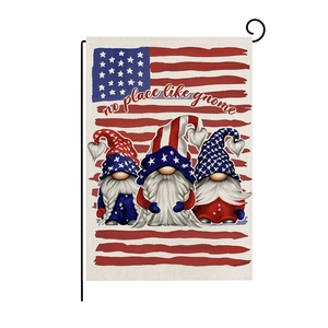 Detail of USA garden flag with gnomes on black metal stand showing burlap texture