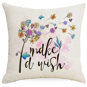 Detail of linen pillowcase featuring a dandelion pattern and I'd make a wish text
